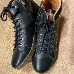 Black ankle boots with studded detail.